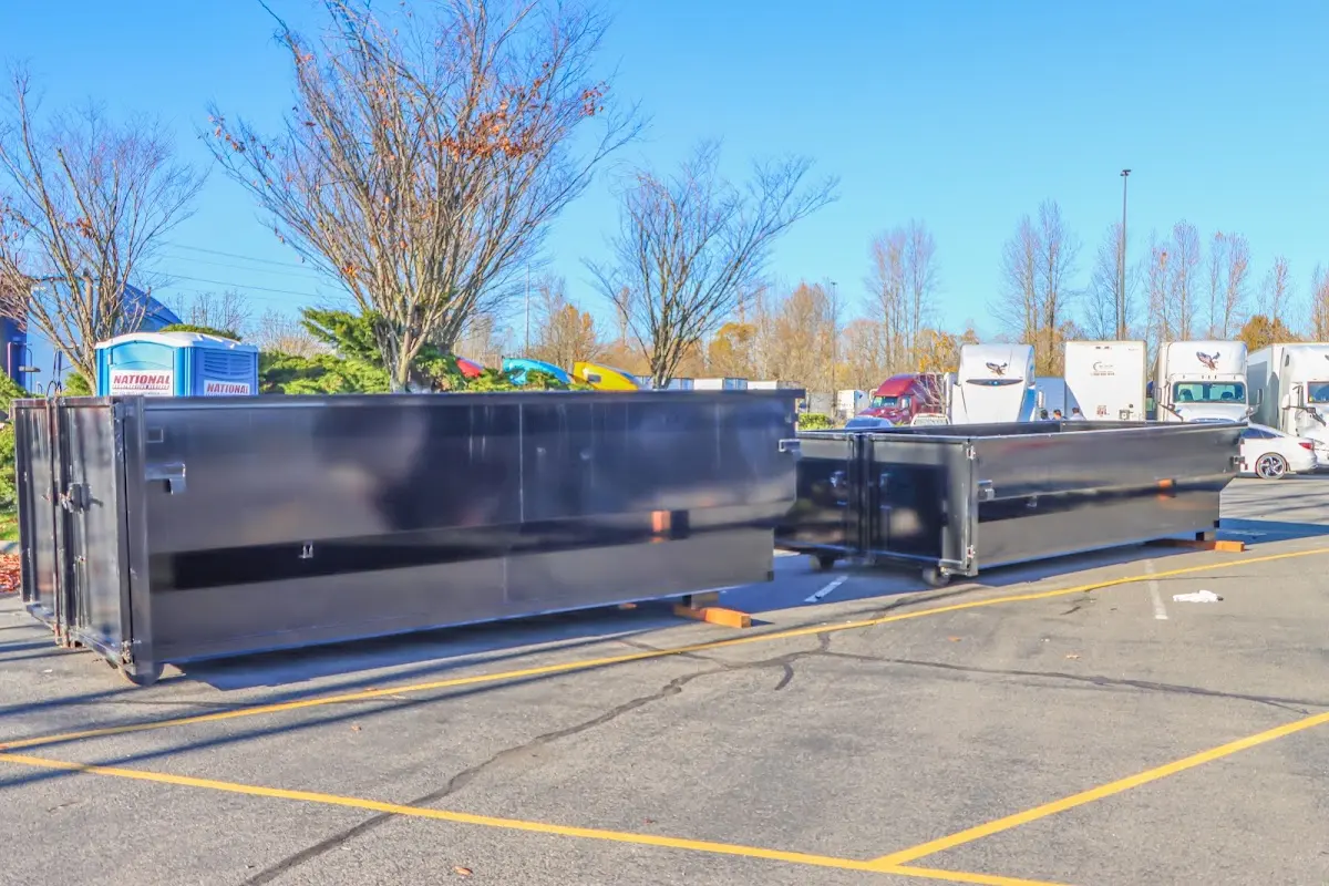 Professional dumpster rental service with roll-off container on residential driveway in Micco